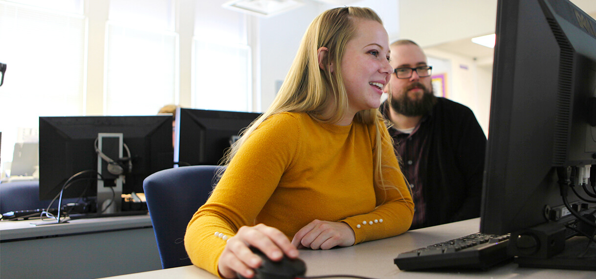 FHTC Computer Program Design student at computer with instructor