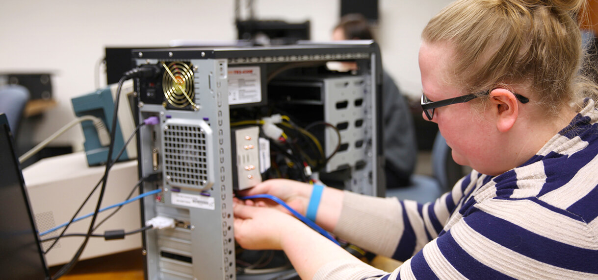 FHTC Network Technology student repairing computer